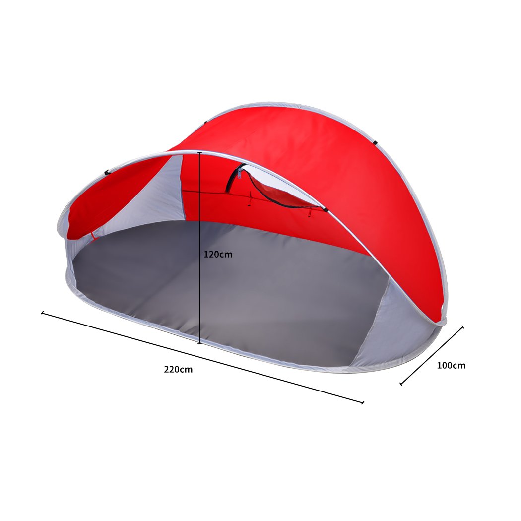 Mountvie Pop Up Tent in red color, spacious enough for 4 people, set up on a beach with a carry bag beside it.